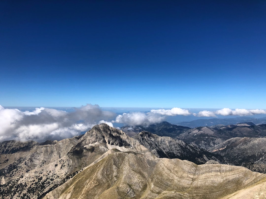 a view of a mountain range with clouds in the sky