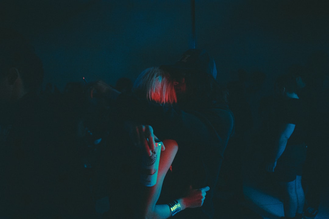 a group of people standing in a dark room