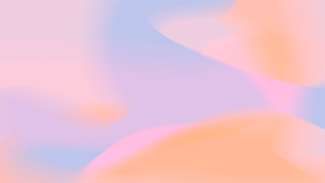 A blurry image of a pink and blue background